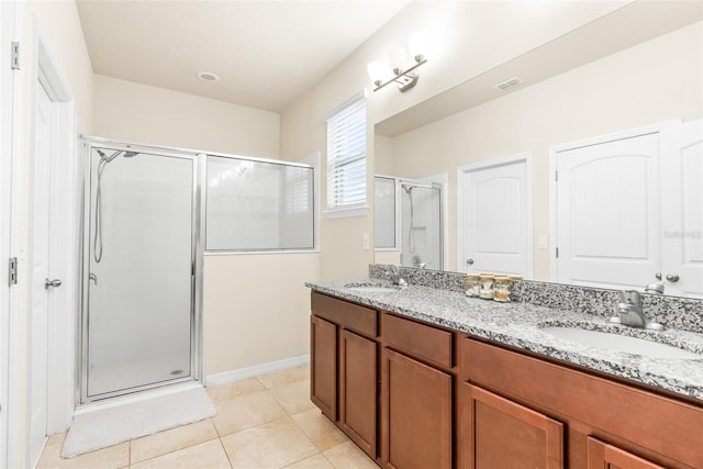 bathroom featuring a shower with shower door, tile patterned floors, and vanity