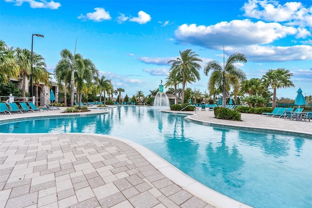 view of swimming pool with pool water feature