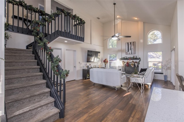 living room featuring ceiling fan, dark hardwood / wood-style flooring, and high vaulted ceiling