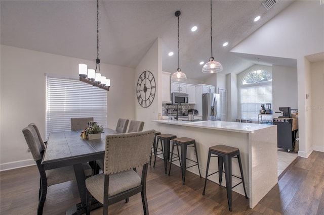 dining room featuring lofted ceiling and hardwood / wood-style flooring