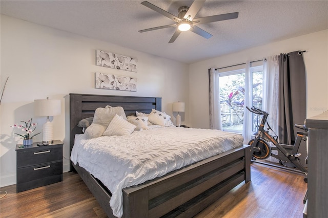 bedroom featuring ceiling fan, dark hardwood / wood-style flooring, and a textured ceiling