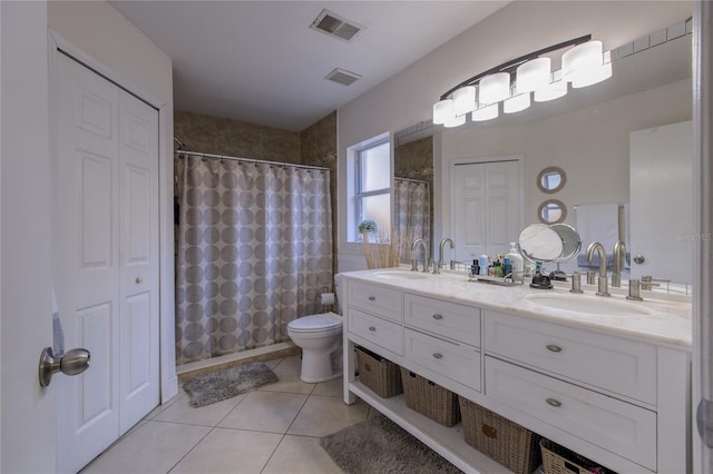 bathroom with a shower with shower curtain, vanity, tile patterned floors, and toilet