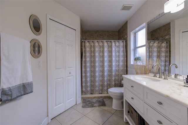 bathroom featuring toilet, vanity, tile patterned floors, and a shower with curtain