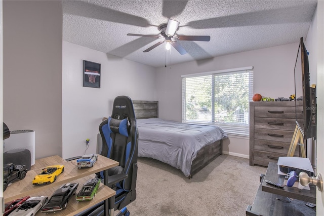 carpeted bedroom with ceiling fan and a textured ceiling