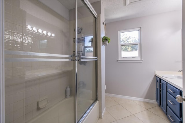 full bathroom with tile patterned flooring, toilet, enclosed tub / shower combo, vanity, and a textured ceiling