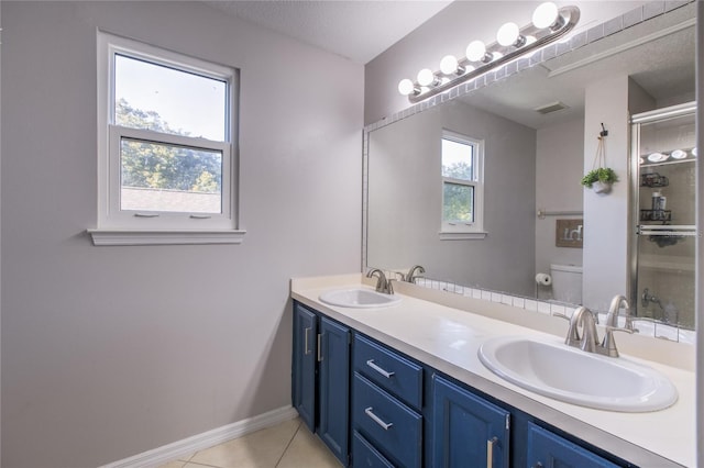 bathroom featuring a textured ceiling, tile patterned flooring, toilet, walk in shower, and vanity