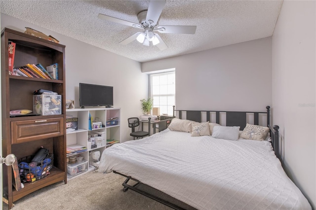 bedroom with a textured ceiling, ceiling fan, and carpet flooring