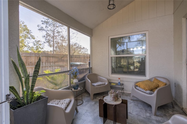 sunroom / solarium featuring lofted ceiling