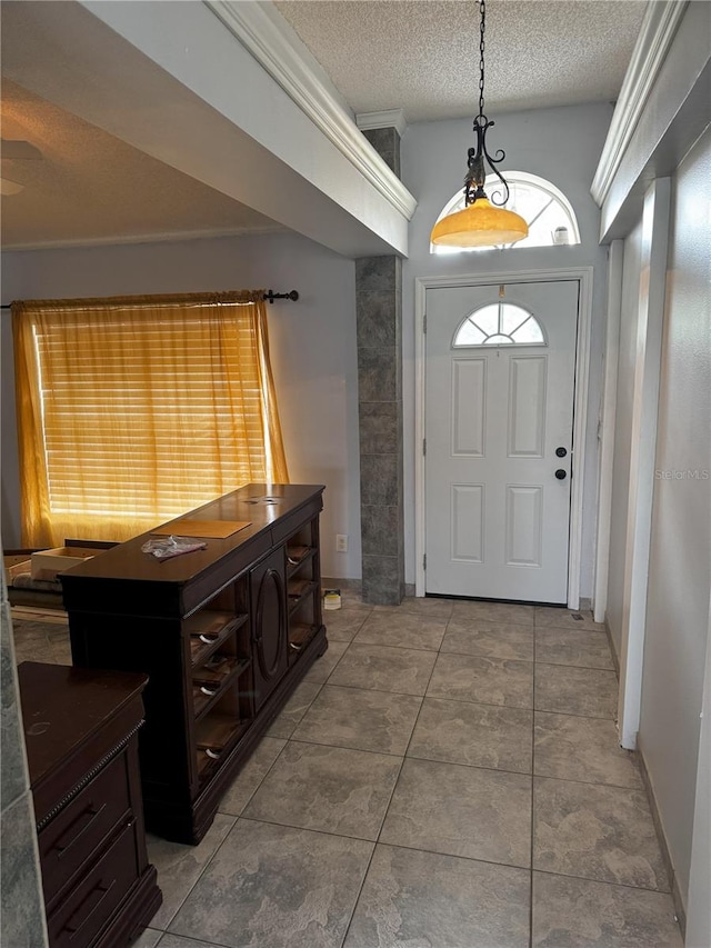 tiled foyer entrance featuring a textured ceiling and vaulted ceiling