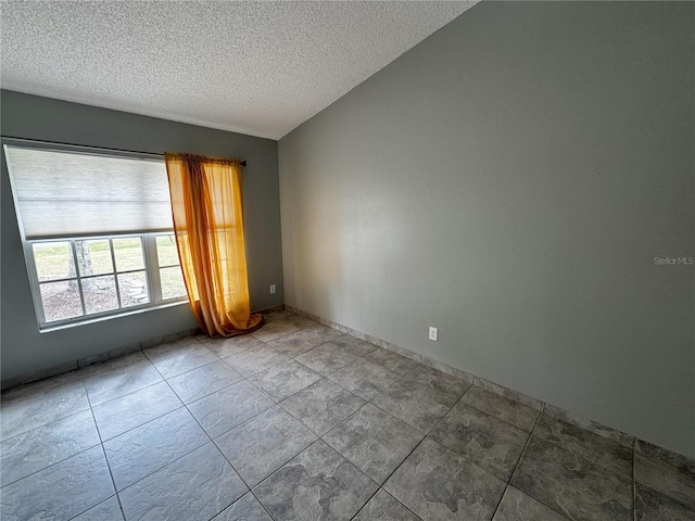 spare room with a textured ceiling