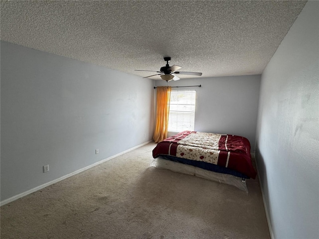 unfurnished bedroom featuring a textured ceiling, ceiling fan, and carpet