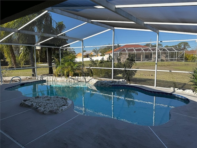 view of swimming pool with a patio, glass enclosure, and a yard