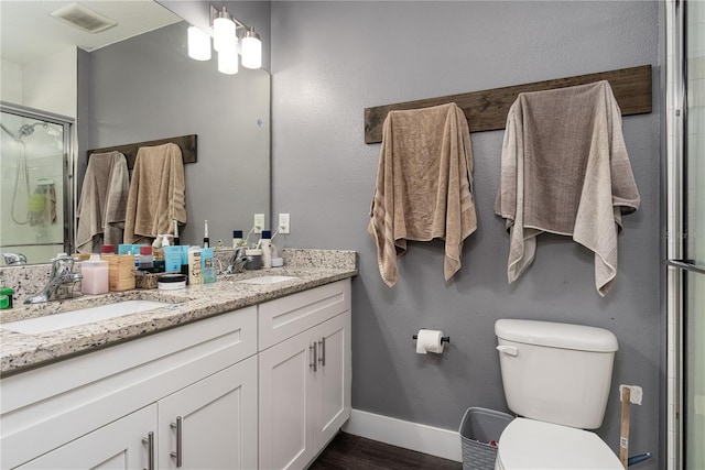 bathroom featuring toilet, an enclosed shower, wood-type flooring, and vanity