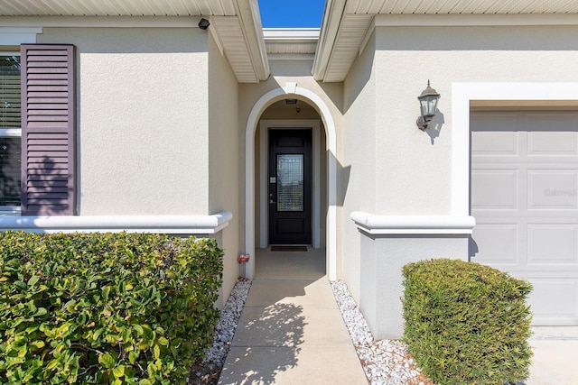 doorway to property with a garage