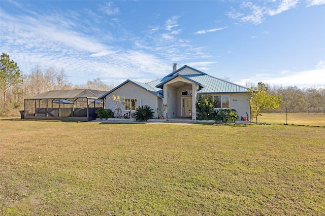 view of front of property featuring a front lawn and glass enclosure