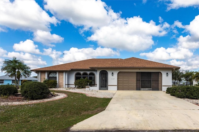 view of front of home featuring a garage and a front yard