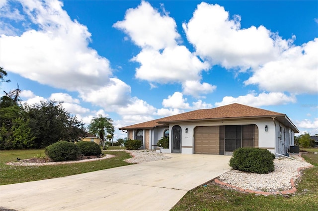 view of front of property featuring central AC and a garage