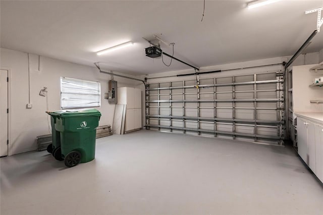 garage featuring a garage door opener and electric panel