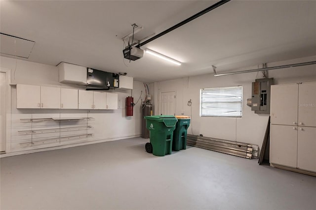 garage with a garage door opener and electric panel