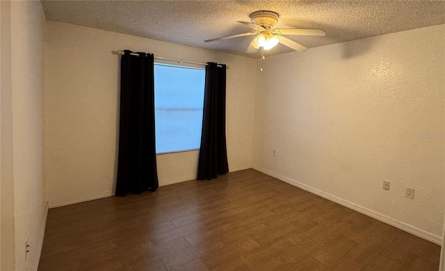 spare room with dark hardwood / wood-style flooring, a textured ceiling, and ceiling fan