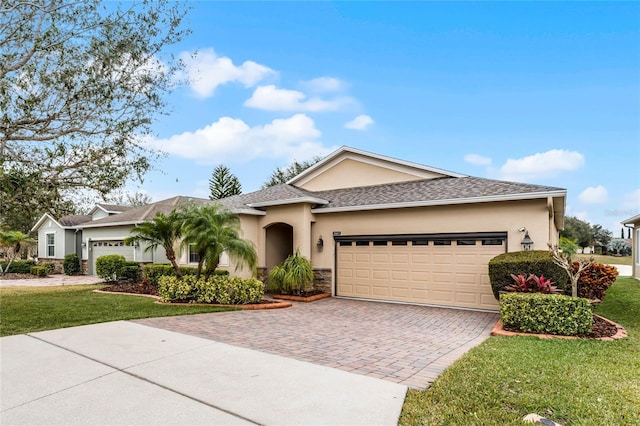 view of front of property featuring a front yard and a garage