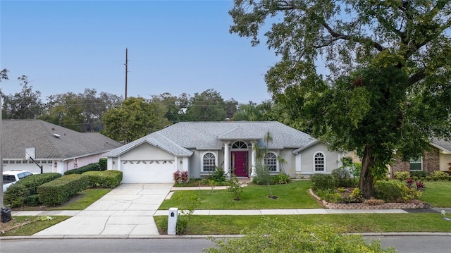 ranch-style home featuring a front lawn and a garage