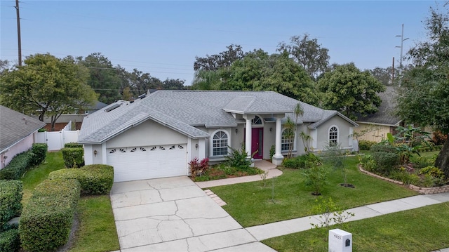 view of front facade featuring a front yard and a garage