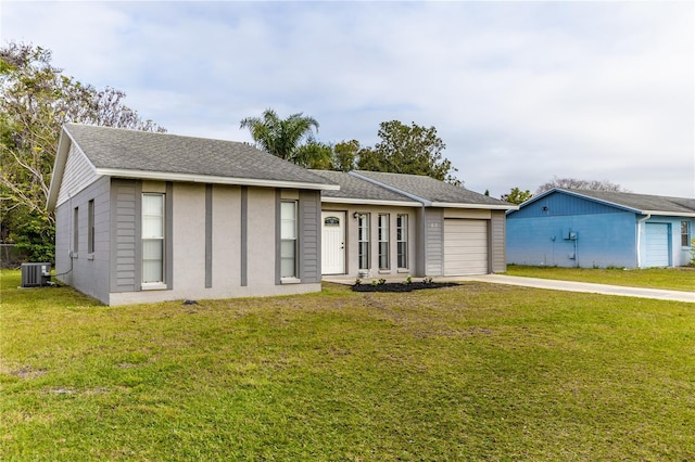 ranch-style home with a garage, central air condition unit, and a front lawn