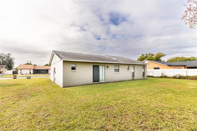 back of property featuring a lawn