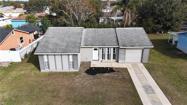 exterior space with a garage and a front lawn