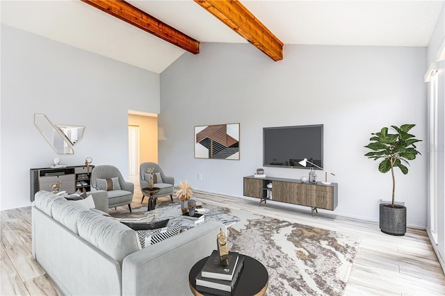 living room featuring vaulted ceiling with beams and light hardwood / wood-style flooring