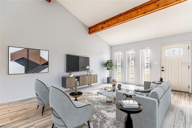 living room featuring lofted ceiling with beams