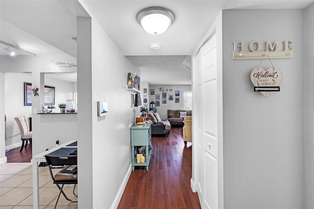 corridor with hardwood / wood-style flooring