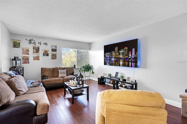 living room with a textured ceiling and dark hardwood / wood-style floors