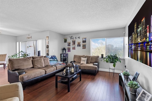 living room with a textured ceiling and dark hardwood / wood-style floors