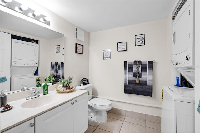 bathroom with toilet, stacked washing maching and dryer, tile patterned flooring, and vanity