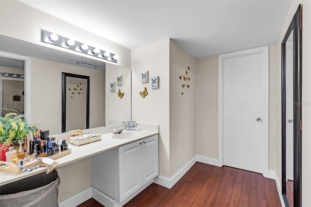 bathroom with hardwood / wood-style flooring and vanity