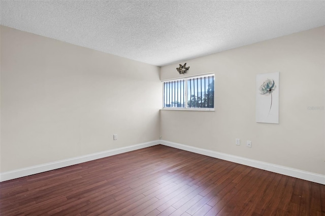 empty room with a textured ceiling and hardwood / wood-style floors