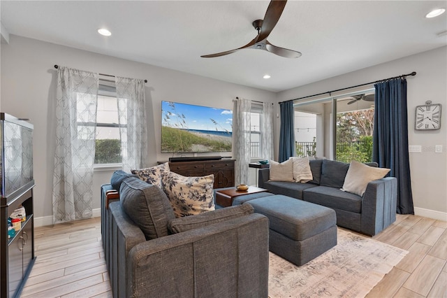 living room with a healthy amount of sunlight and ceiling fan