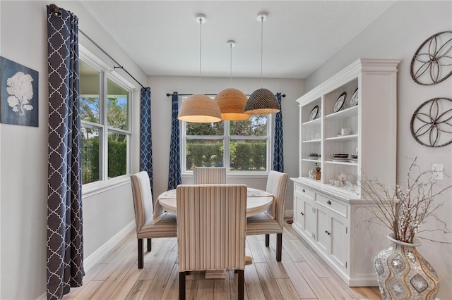 dining space with light hardwood / wood-style flooring