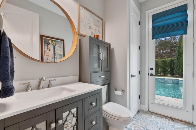 bathroom featuring tile patterned floors, vanity, and toilet