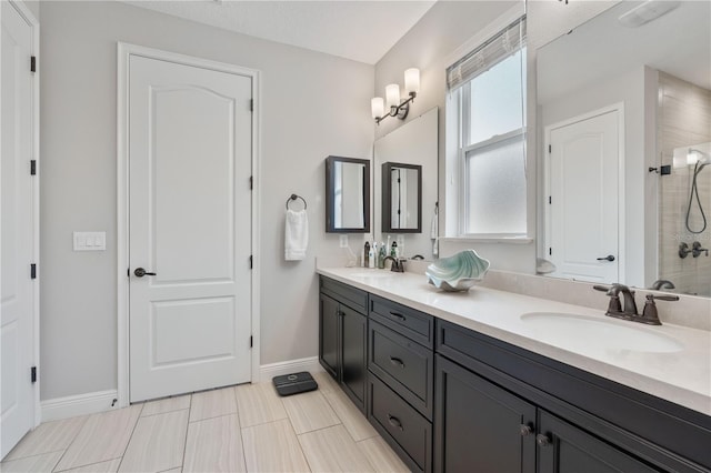 bathroom with a textured ceiling, a shower, and vanity