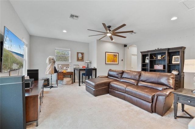 carpeted living room featuring ceiling fan