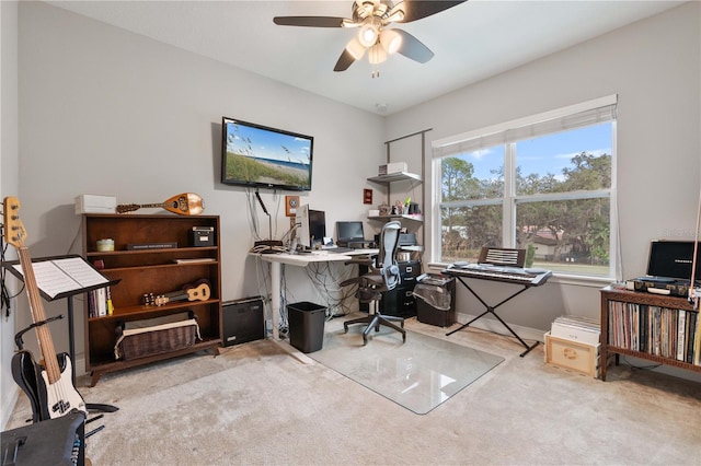 carpeted office featuring ceiling fan