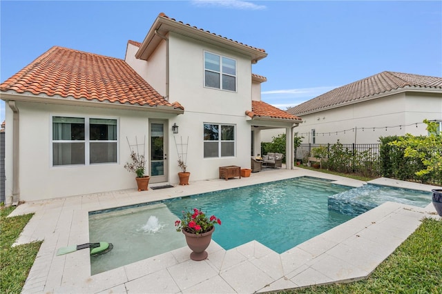 back of house with a fenced in pool and a patio