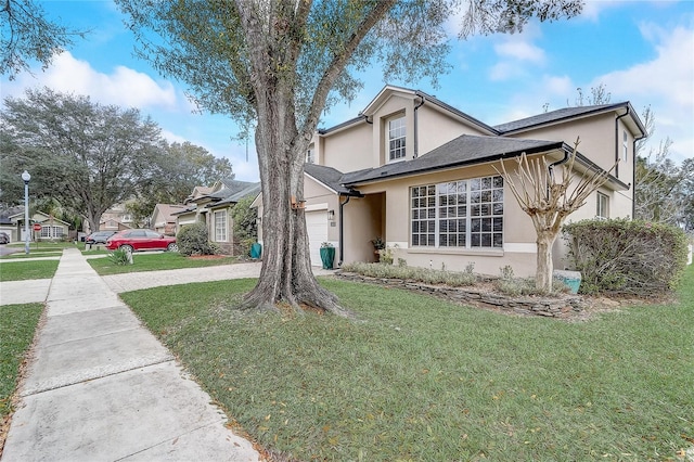 view of front of home with a front lawn and a garage