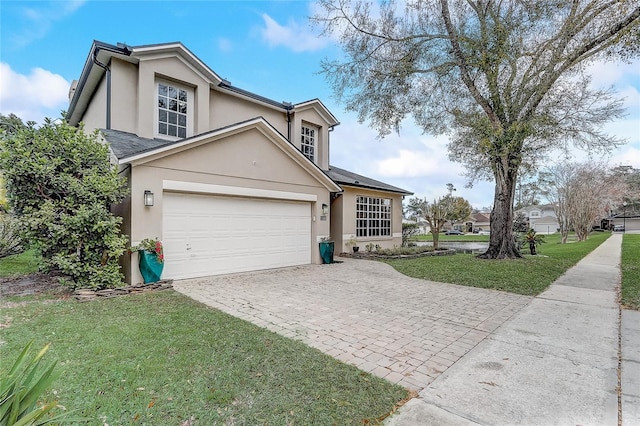 view of front property with a garage and a front lawn