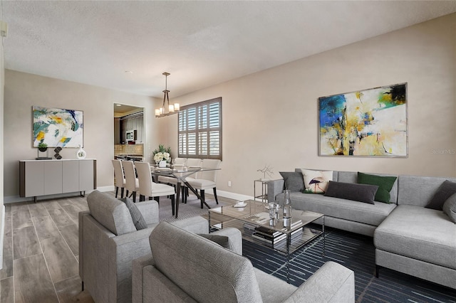 living room with hardwood / wood-style flooring and a notable chandelier