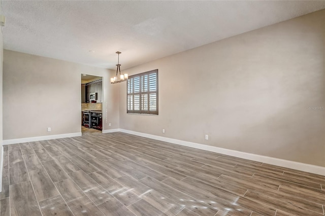 unfurnished living room with a chandelier