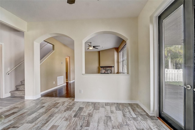 empty room featuring ceiling fan and light wood-type flooring